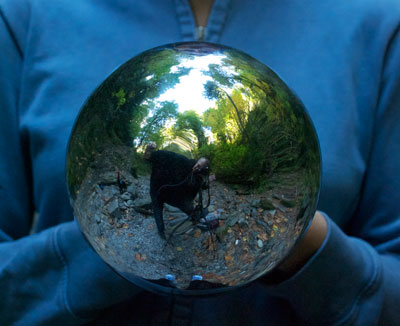 Cheryl Hebert holds mirror ball on location in BC's coastal rainforest