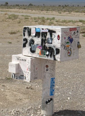 The "black mailbox" is actually dirty white and covered with graffiti