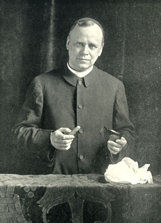 Father C. M. de Heredia shows two séance props—a false finger and a comb with hollow handle—from which "ectoplasm" could be "materialized."